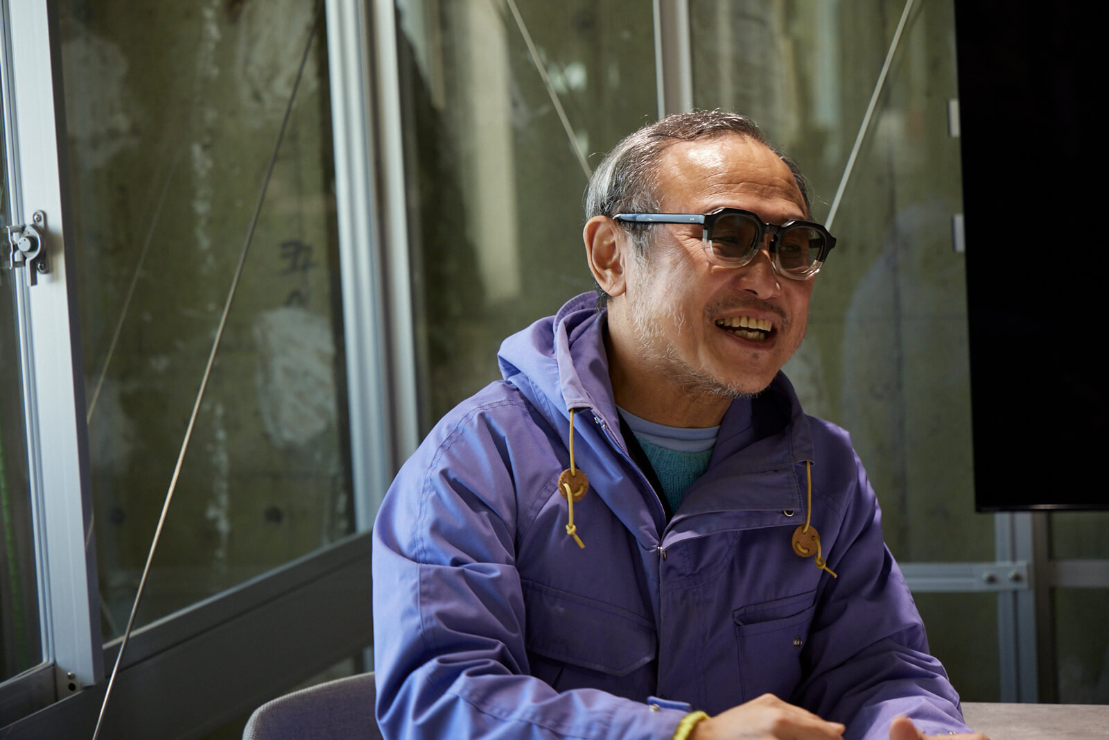 Mr.Toyama answering questions in an interview