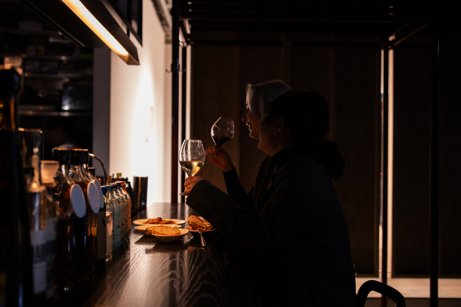 People enjoying wine at the counter