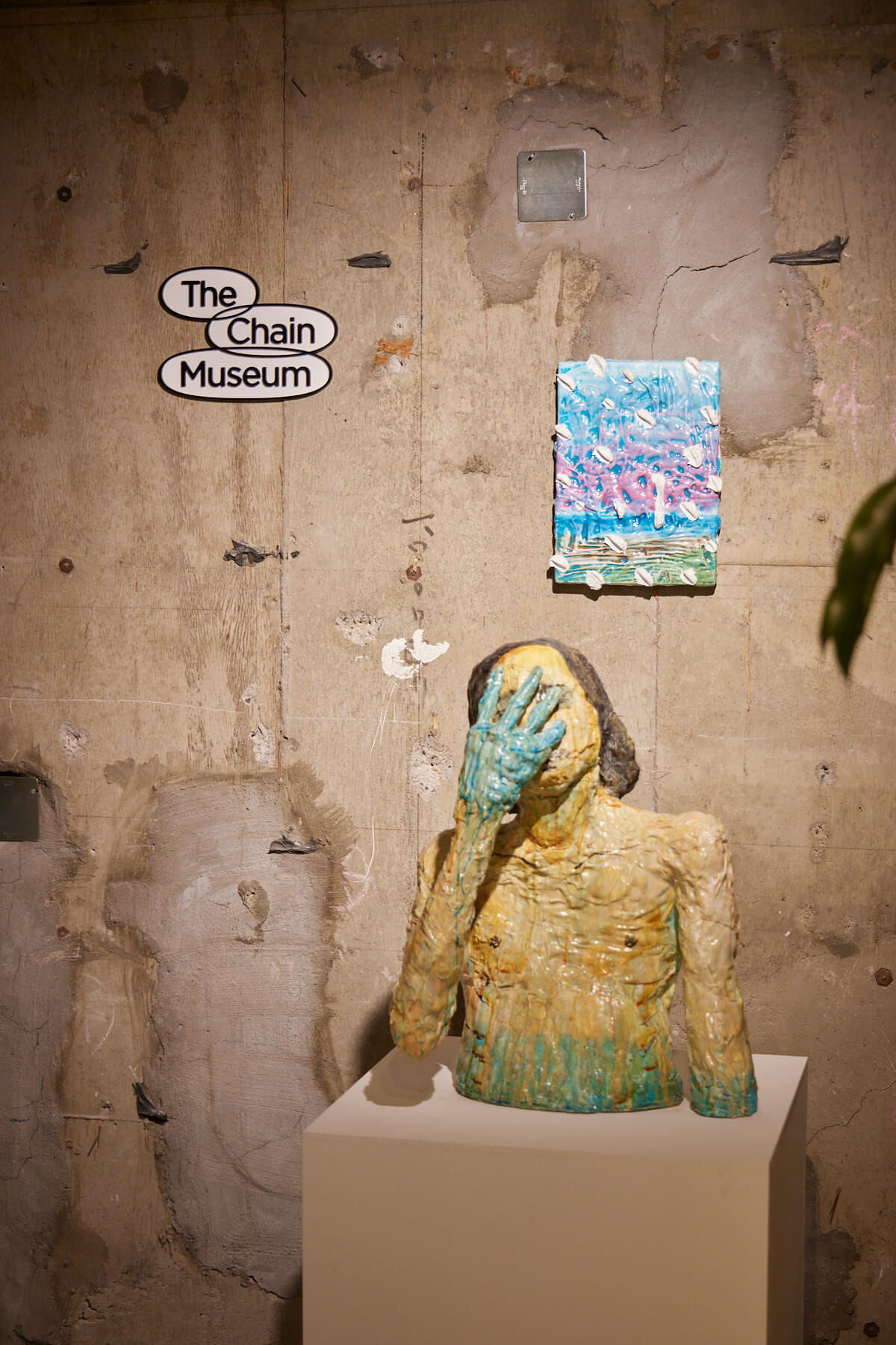 An object that hides the face with one hand